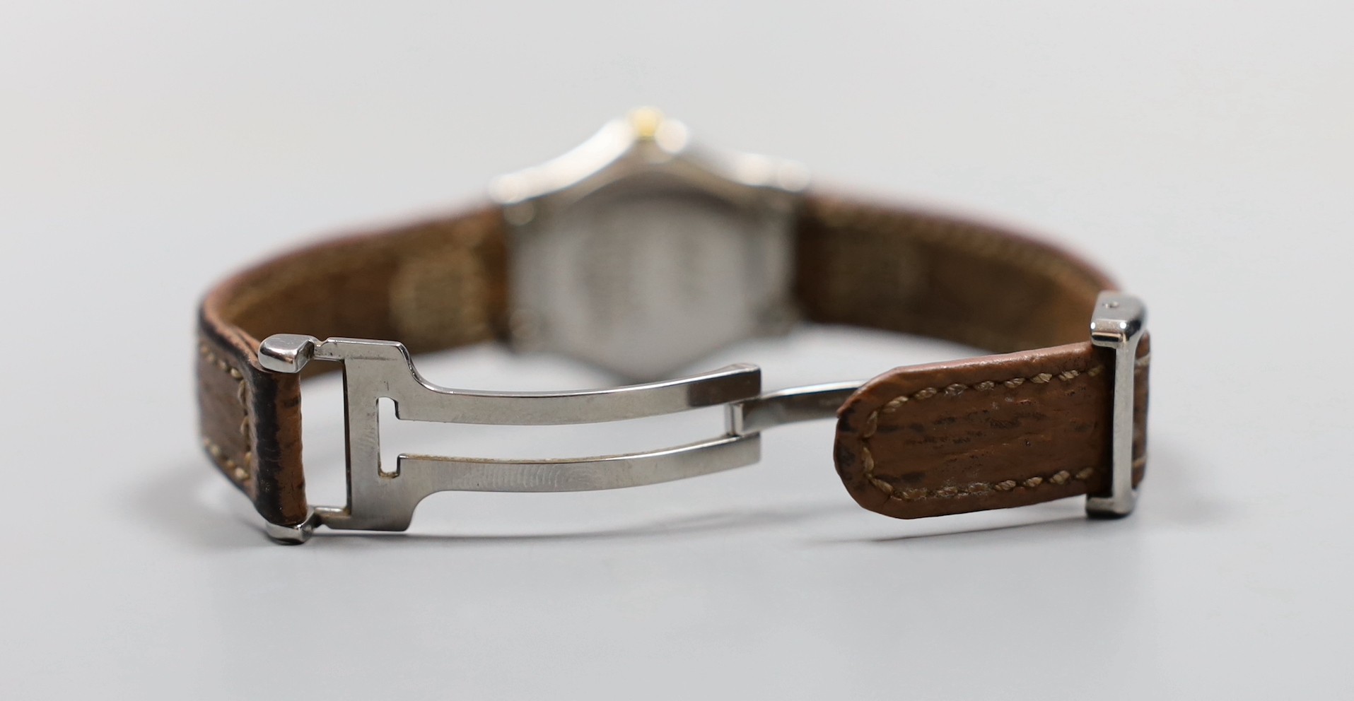 A lady's 18K and steel Ebel 1911 quartz wrist watch, on a leather strap with steel deployment clasp, no box or papers.
